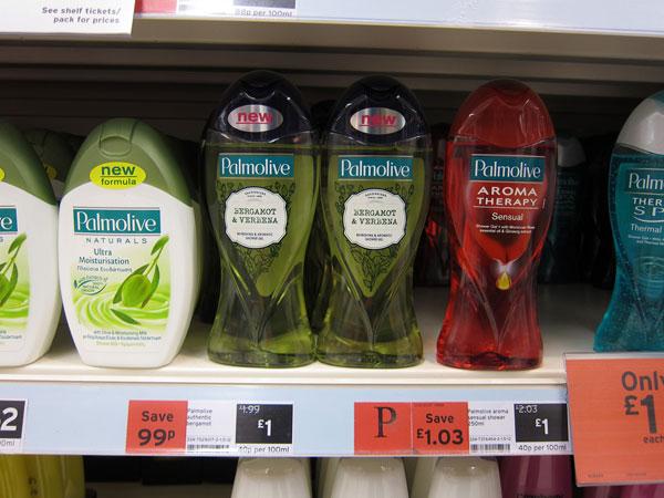 Several transparent bottles from Palmolive on shelf in a supermarket